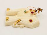 a picture of a pair of earrings that are on a white surface