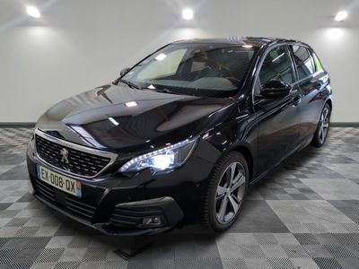 la voiture noire est garée sur un sol en damier dans le garage