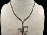 a white mannequin with a silver cross on it