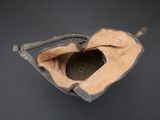 an overhead view of a baseball mitt with a baseball cap on it