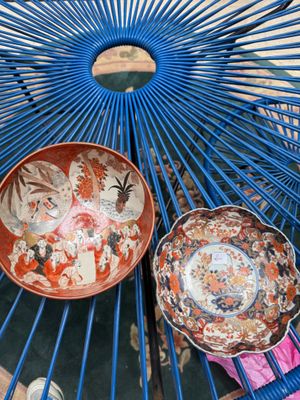 a blue metal chair with two plates on top of it