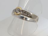 a close up of a ring with a diamond on it