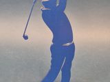 statue of a man swinging a golf club on a blue base