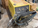 a man working on a machine in a garage
