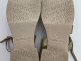 the soles of a pair of sandals with a bow on them