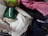 a pile of clothes in a bag on the floor