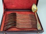 spoons and spoon rest in a case on a white surface