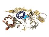a pile of assorted bracelets and necklaces on a white surface
