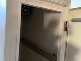 a door that is open in a room with tile flooring