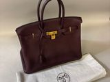 hermes handbag in burgundy leather with gold hardware and pouch