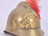 a gold helmet with a red feather on top of it