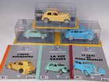 four different model cars are in a display case on a white surface