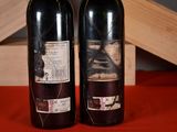 two bottles of wine that are sitting on a table