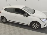 the small white car is parked in a room with a checkered floor