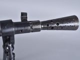a metal object with holes on it on a white surface