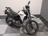 a motorcycle that is parked on a checkered floor