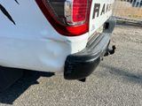 a white truck that has a sticker on the back of it