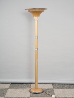 a wooden floor lamp on a checkered floor in front of a white wall