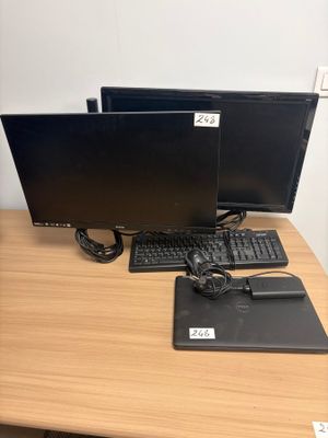 two computer monitors and a keyboard on a desk