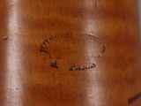 a close up of a brown leather boot with a black label on it