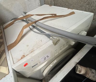 a dirty washer and dryer in a dirty room