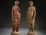two statues of a man and a woman standing next to each other