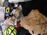 a bag full of items sitting on top of a bed
