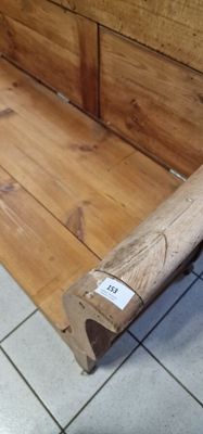 a wooden bench that is sitting on a tile floor
