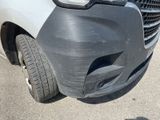 a car that has been dented and is parked in the parking lot