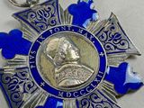 a close up of a medal on a white surface with blue hearts