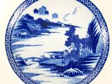an image of a blue and white plate with a landscape on it