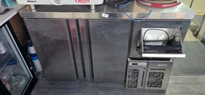 two refrigerators and a freezer in a kitchen