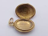 a small gold locke with a key in it