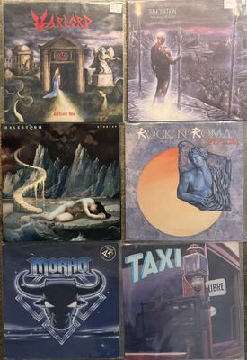 several albums of heavy rock and heavy metal music are on a table