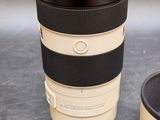 a camera lens sitting next to a coffee cup on a table