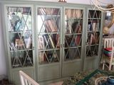 a book case with many books on it in a room