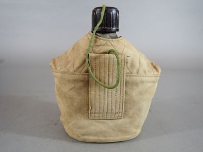 a bottle that is sitting on a table next to a bag