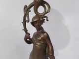bronze statue of a woman holding a bowl on top of a stand