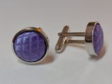 pair of purple cufflinks with silver plated setting on a white background
