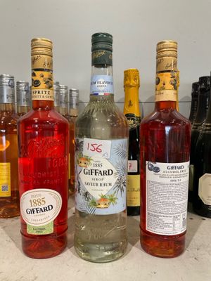 many bottles of alcohol lined up on a counter