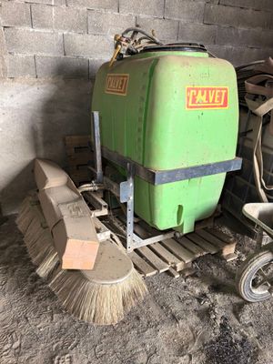 an image of a green machine and a broom in a room