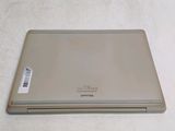 a laptop computer sitting on a table with a sticker on it