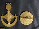 some gold metal items are laying out on a black cloth