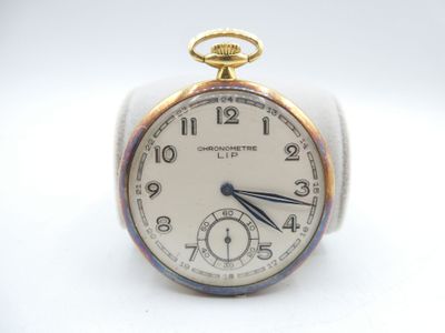 an image of a close up of a pocket watch on a white surface