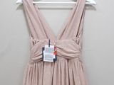 the dress is hanging on a hanger on the wall