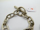 a silver bracelet with a chain attached to it