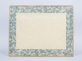 an old picture frame with a blue and white floral design