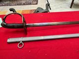 a sword that is laying on a red table