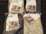 three bags of blankets are sitting on a blanket on a bed