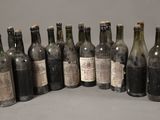 several bottles of wine are lined up in a row on a table